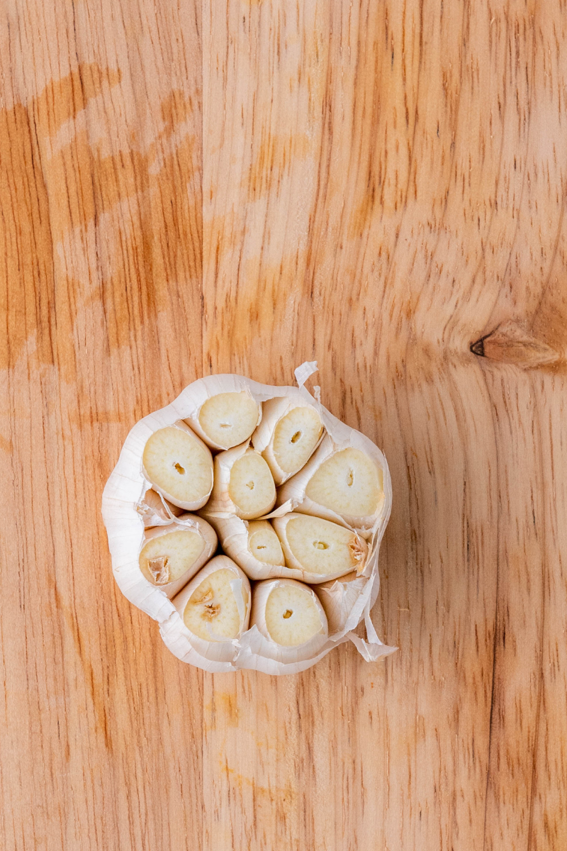 Garlic bulb sliced in half for homemade quesabirria tacos.