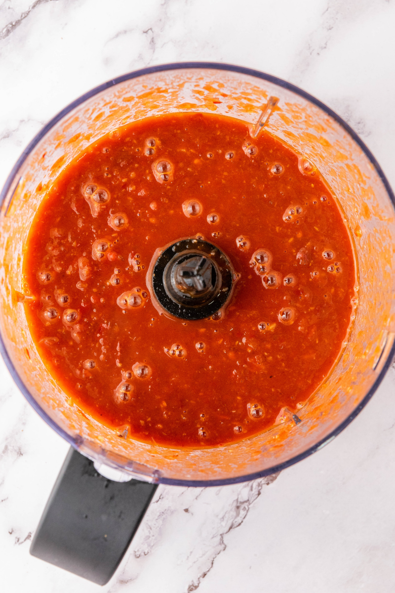 Smooth blended red birria sauce inside blender.