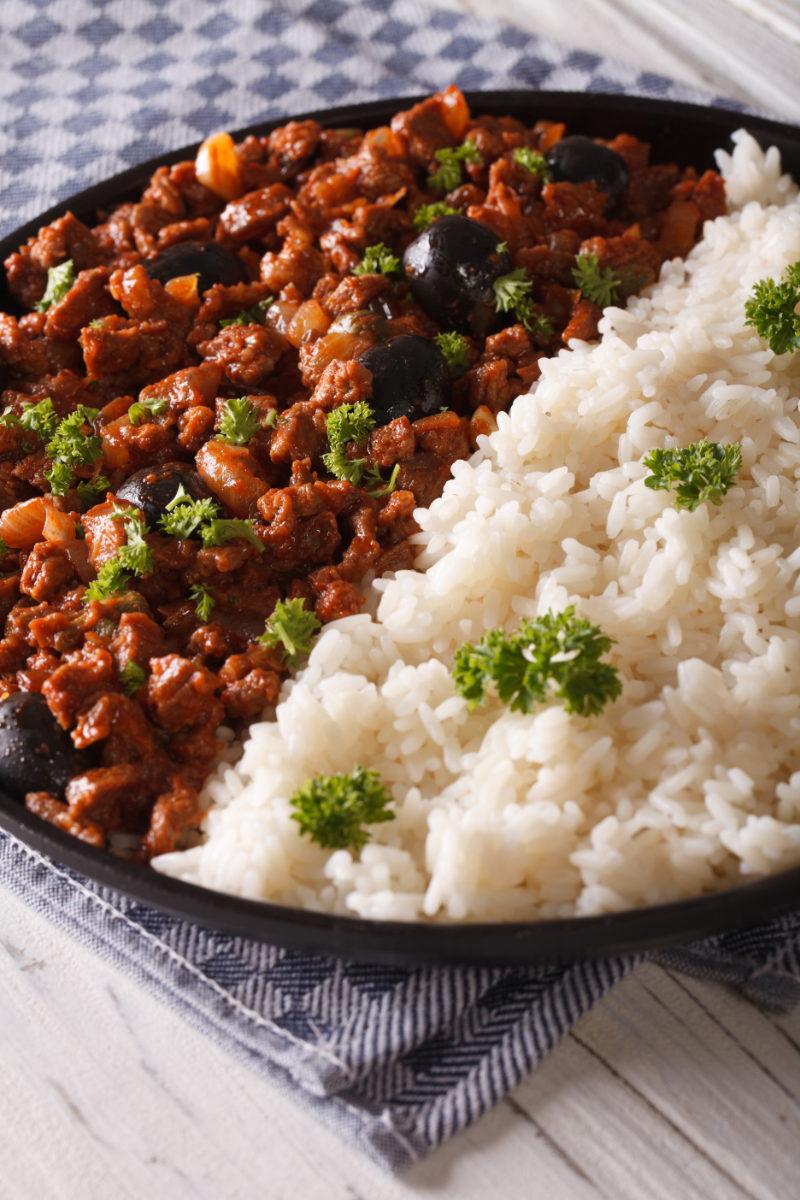 Easy Cuban picadillo recipe made with ground beef, peppers, olives, and tomato sauce served in a skillet