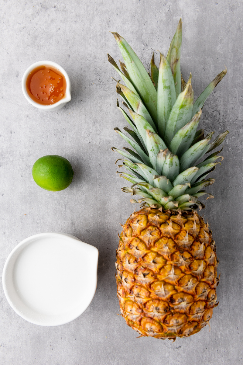 Fresh pineapple, coconut milk, lime, and honey for homemade pineapple coconut lime popsicles.