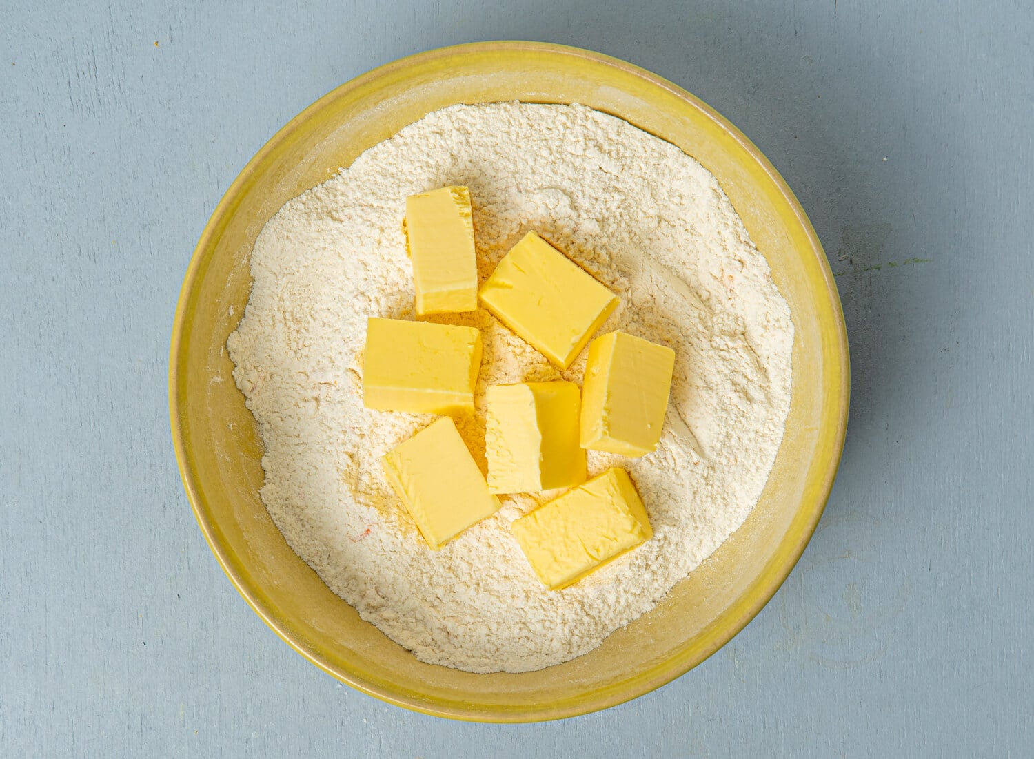  Cold cubed butter added to the flour mixture for orange cranberry scones.