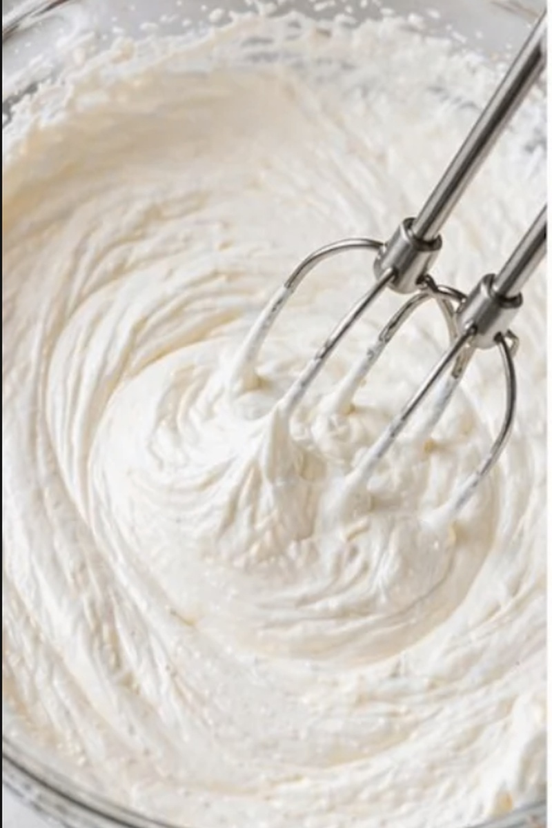 Homemade whipped cream whipped to soft peaks for strawberry shortcake.