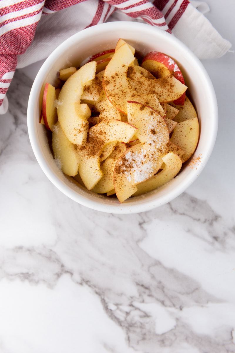 Apple slices tossed with cinnamon sugar for sweet apple rose puff pastry filling.