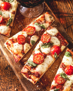 Deliciously baked Margherita Flatbread Pizza topped with fresh mozzarella, tomatoes, and basil.