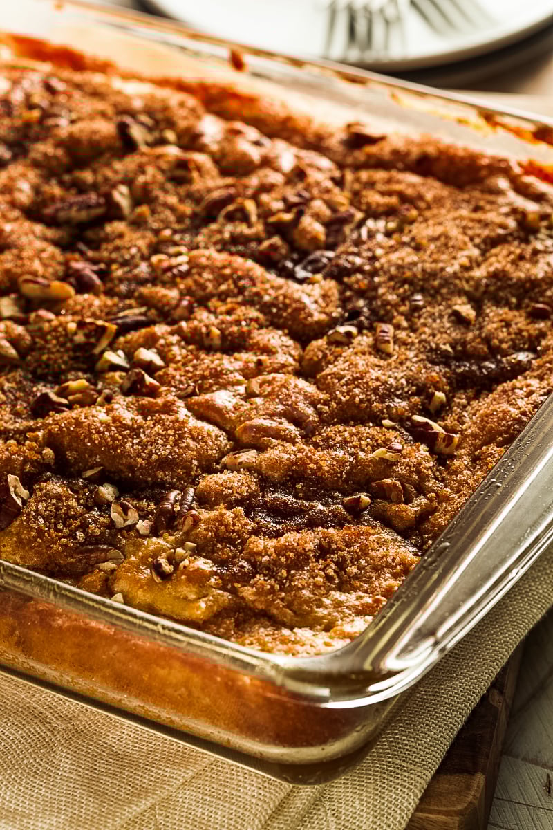 Moist cinnamon coffee cake with crumb topping on a white plate”