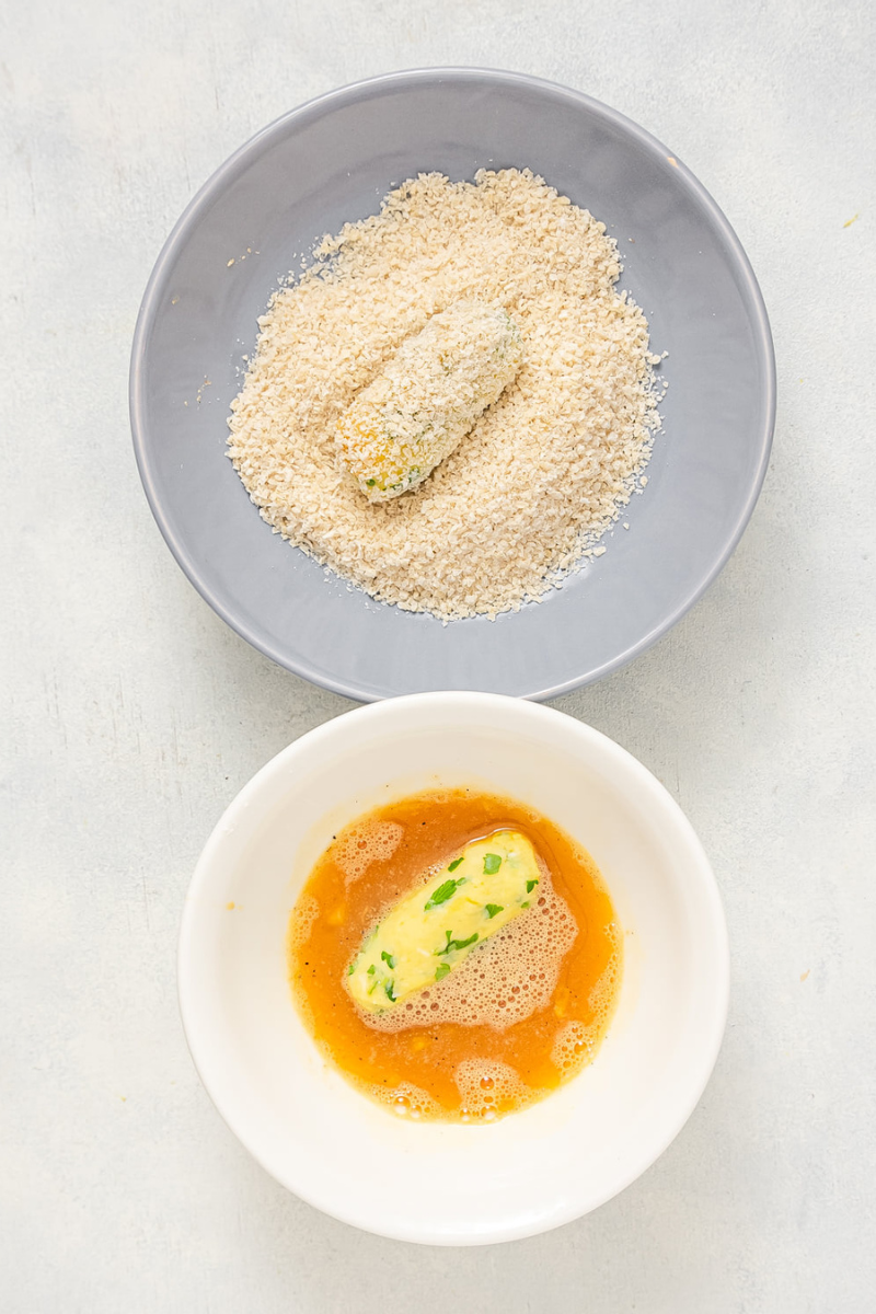 adding breadcrumbs to croquettes