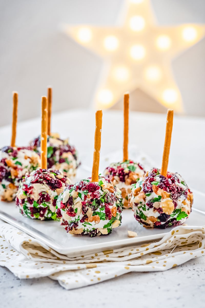 Cranberry Cheese Ball on festive holiday platter with crackers