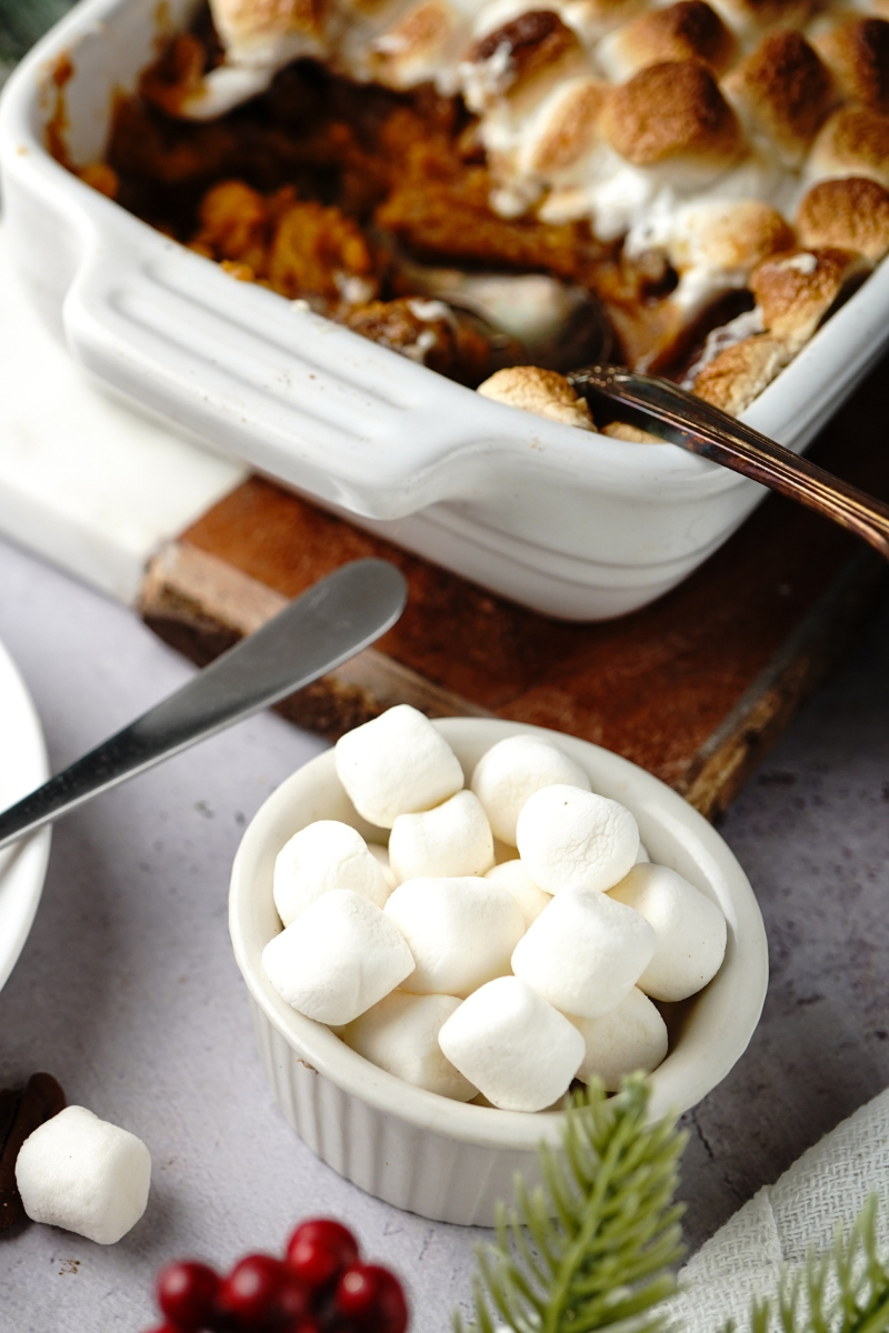 Baked sweet potato casserole in a casserole dish with golden toasted marshmallows on top.