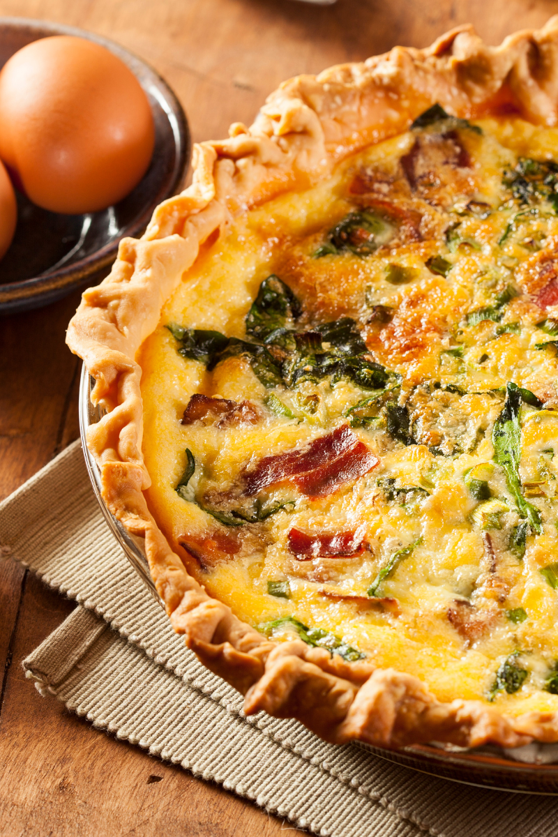 Golden-baked Spinach and Bacon Egg Quiche fresh out of the oven, with a fluffy custard and crispy bacon bits on top
