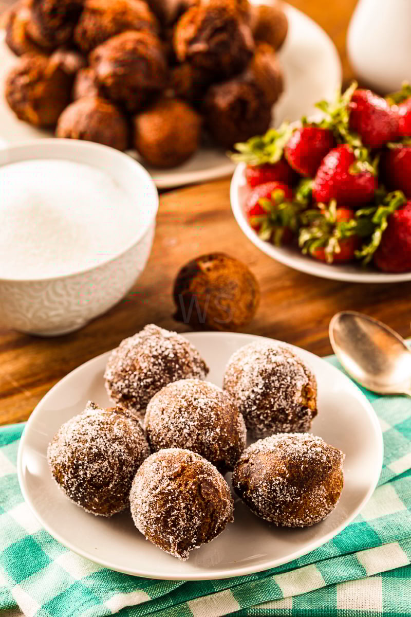 Healthy chocolate donut holes stacked on a plate, baked in the air fryer with a soft, rich center and no frying.