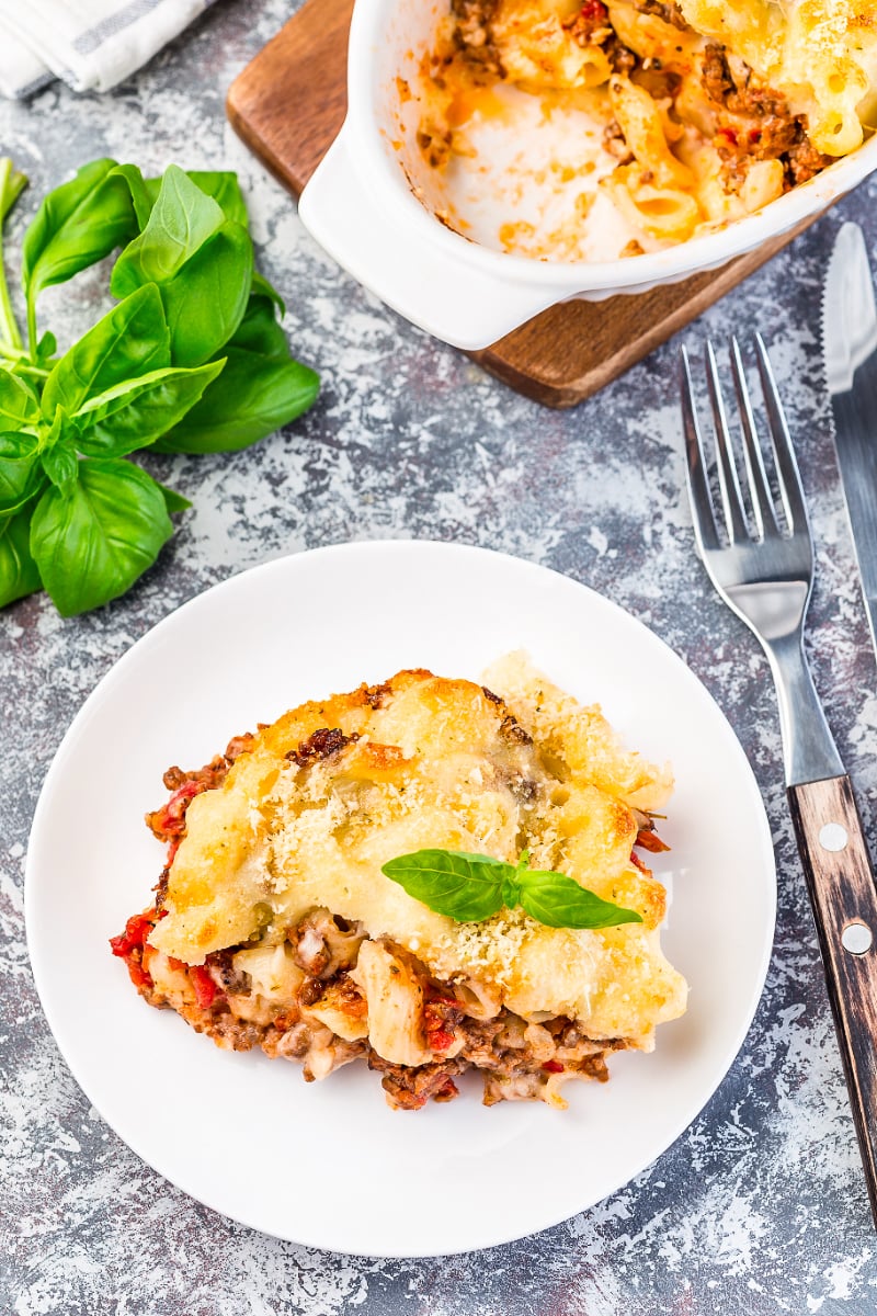 Close-up of a plated slice of macaroni casserole with ground beef, highlighting the cheesy, hearty layers.