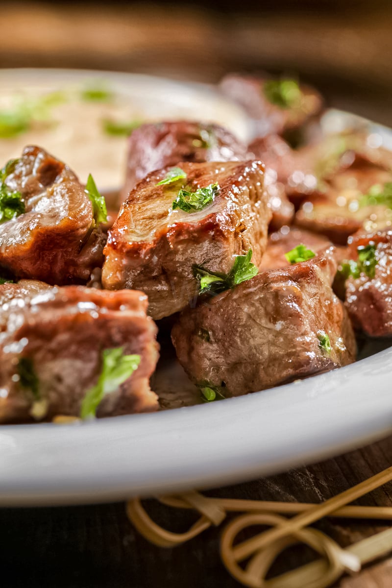 Juicy steak bites coated in garlic butter with a side of chipotle mayo