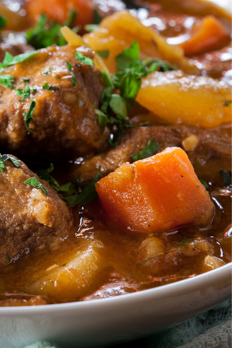 Classic Irish beef stew in a ceramic bowl, thick gravy with beef and root vegetables