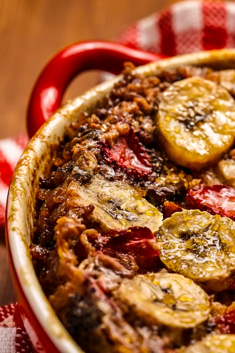 Oven-baked strawberry banana oatmeal casserole set and ready to slice in a ceramic dish
