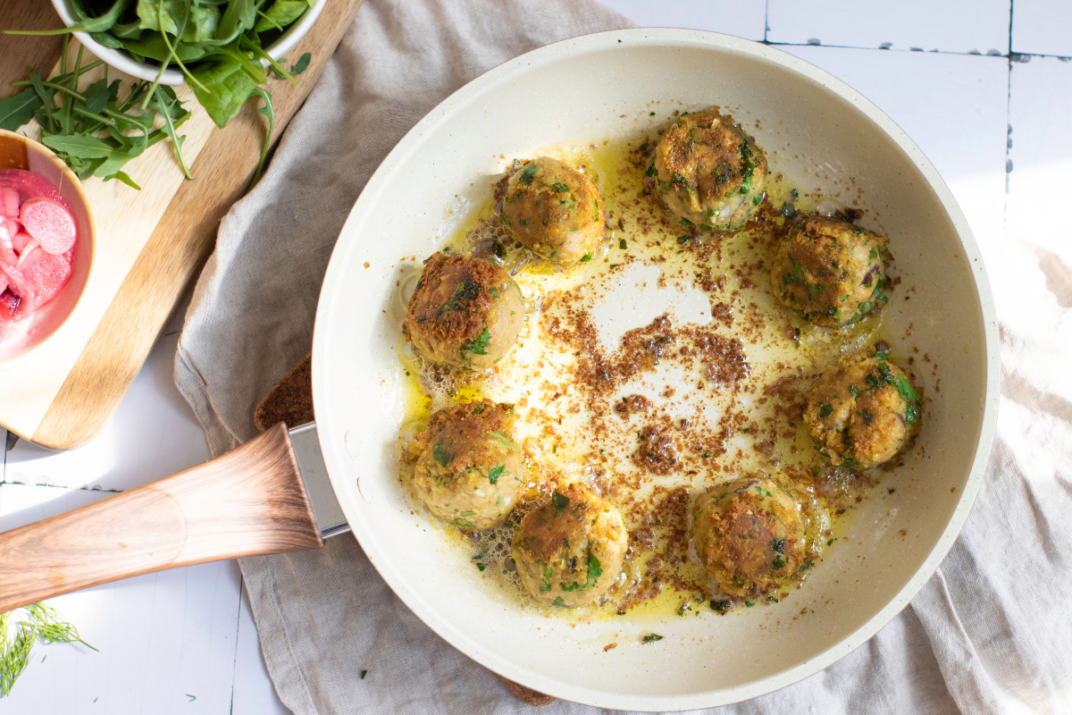 Folded crispy falafel wrap filled with tzatziki, pickled onions, radishes, cherry tomatoes, greens, feta, and fresh herbs.