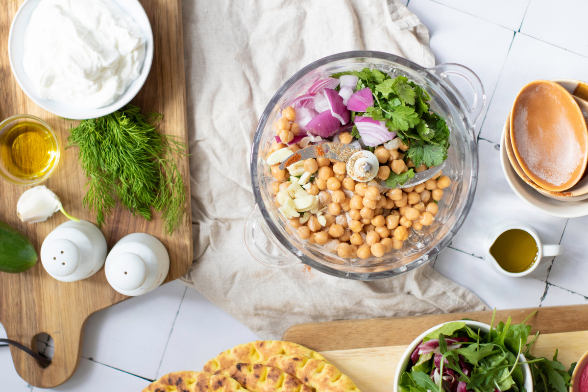 Homemade falafel balls cooking in olive oil in a skillet until golden brown and crispy on the outside.