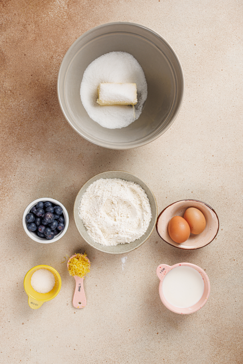 Softened butter and granulated sugar in a mixing bowl for making lemon blueberry cake batter.