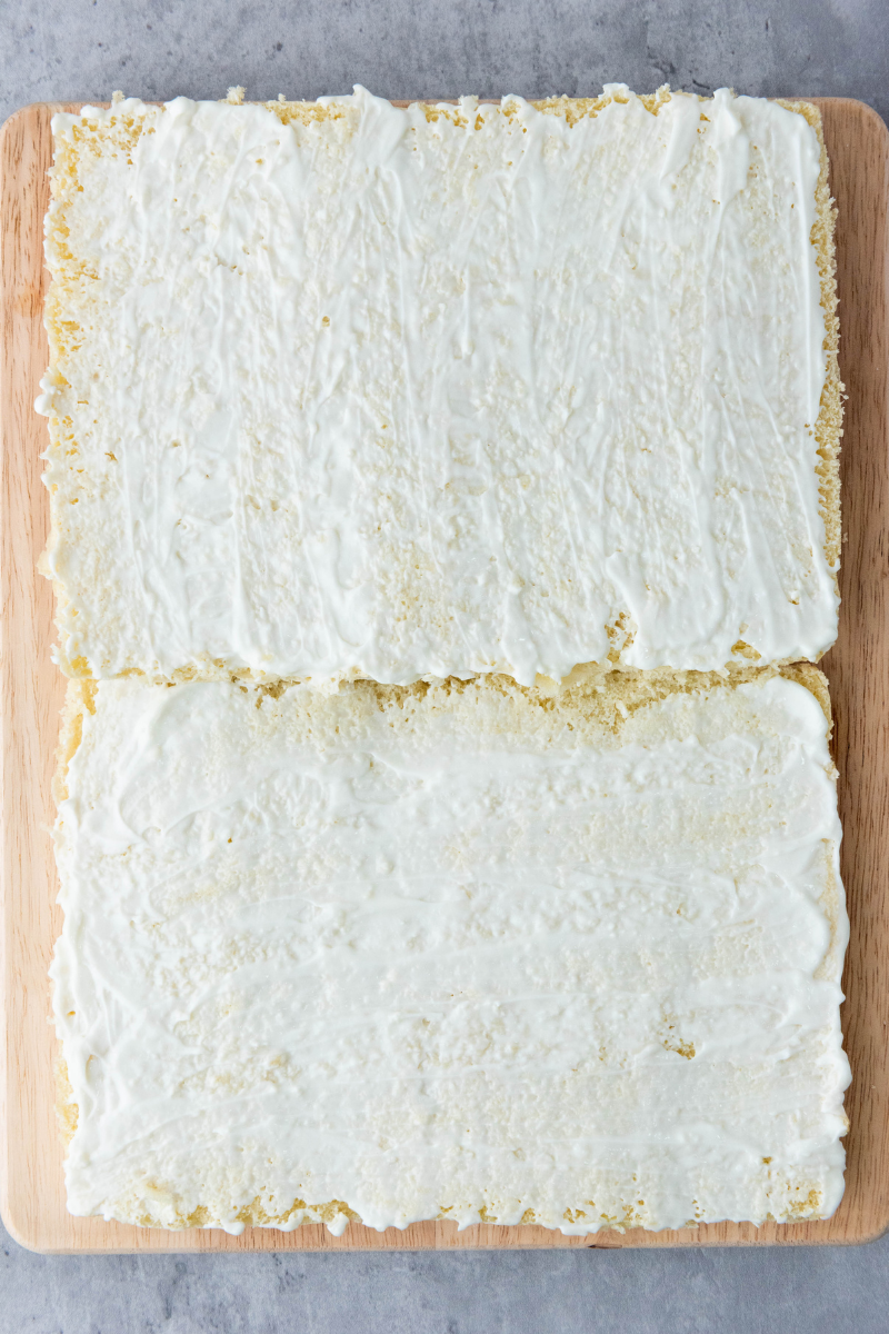 Mayonnaise spread evenly over sliced slider buns before adding ham and cheese.
