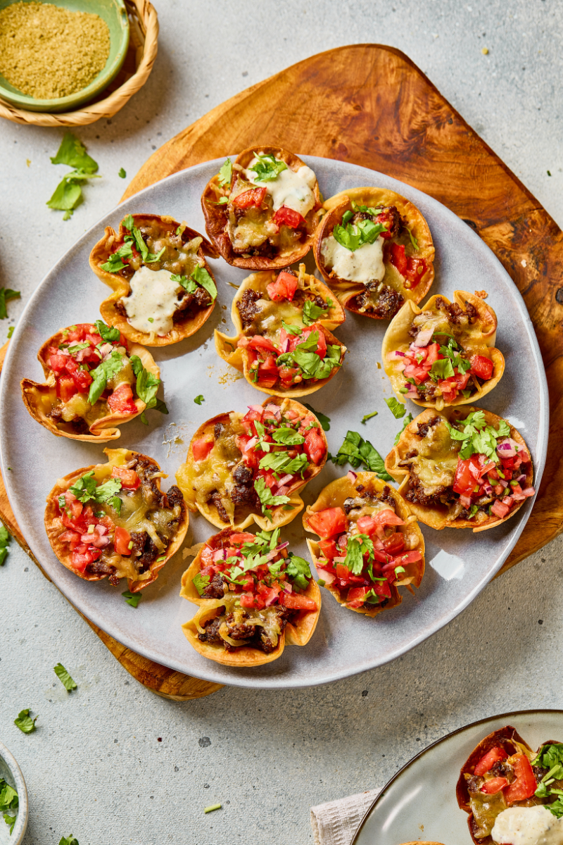 Crispy Taco Ranch Bites topped with melted cheese, tomatoes, and cilantro."