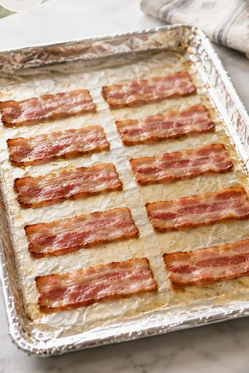 Partially cooked bacon strips after the first bake.
