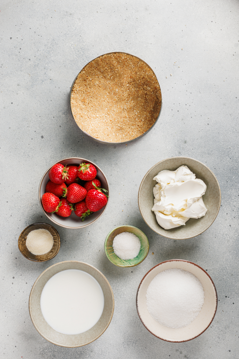 Graham cracker crust pressed firmly into a springform pan for no-bake strawberry cheesecake.