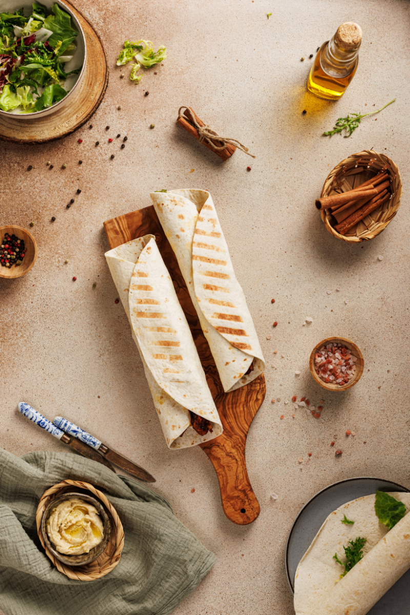 Grilled Moroccan chicken wraps arranged on serving board