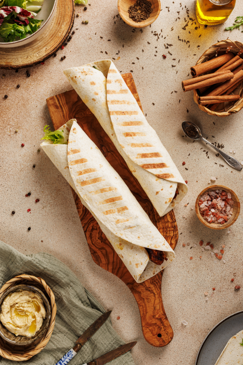 Close-up of toasted Moroccan chicken wraps with grill marks
