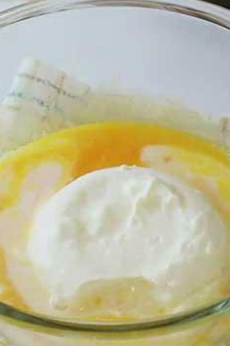 Mascarpone cheese being added to whipped egg yolks for blueberry tiramisu filling