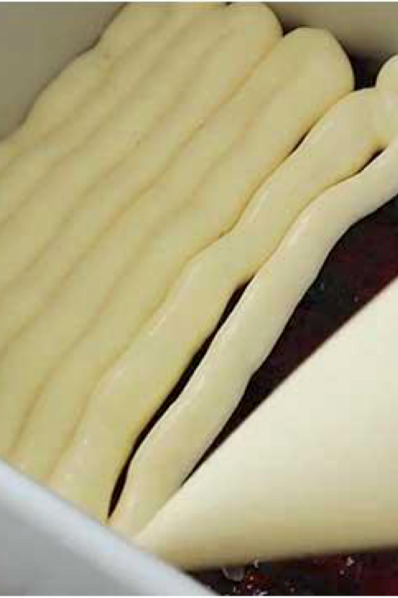 Mascarpone filling piped over blueberry layer while assembling blueberry tiramisu