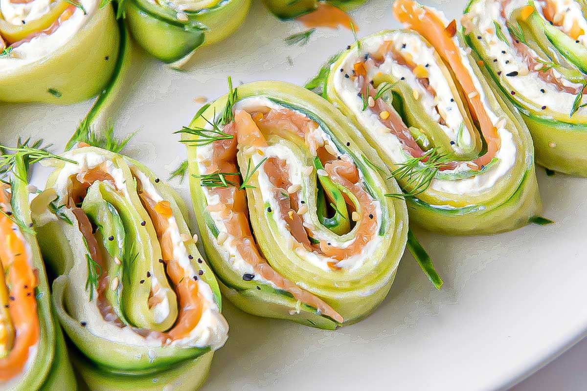 Close-up of Everything Bagel Cucumber Rolls filled with cream cheese and smoked salmon, garnished with fresh dill.