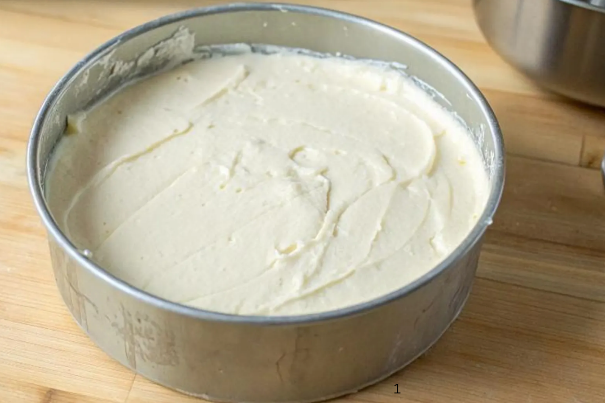  Smooth no-bake cheesecake filling spread evenly inside a round springform pan.