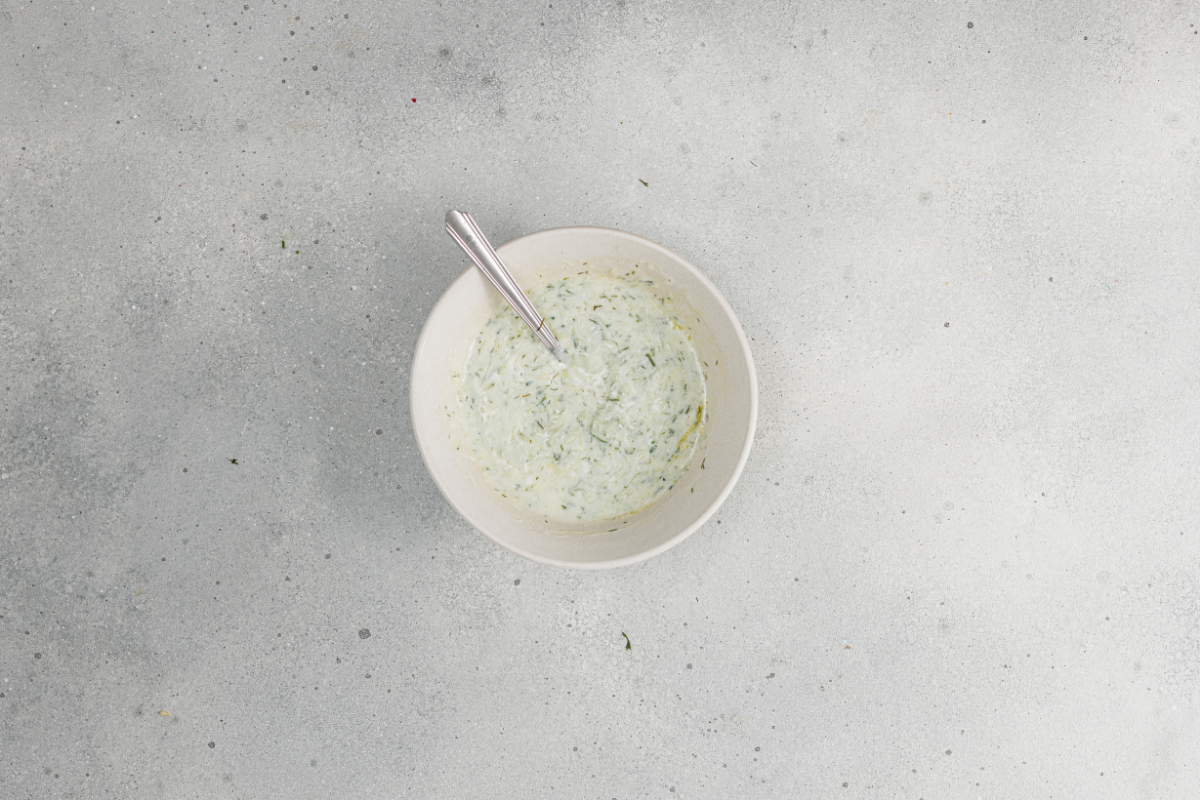  Mixing fresh Mediterranean tzatziki sauce until smooth.