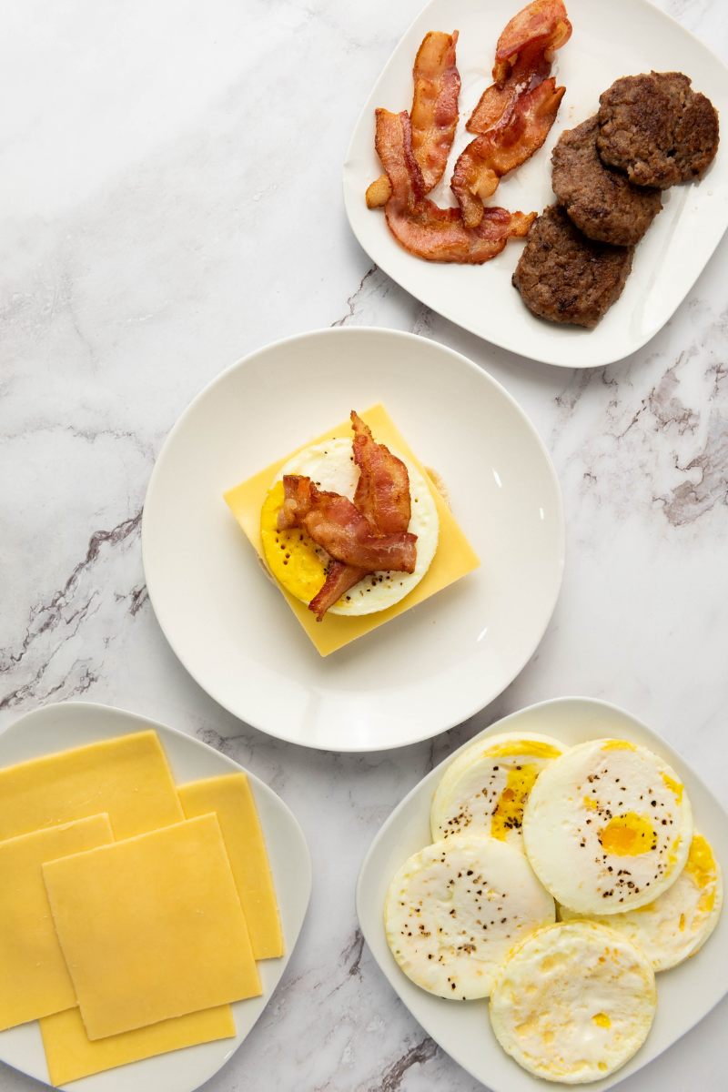 Crispy bacon layered over an egg and cheese breakfast sandwich.