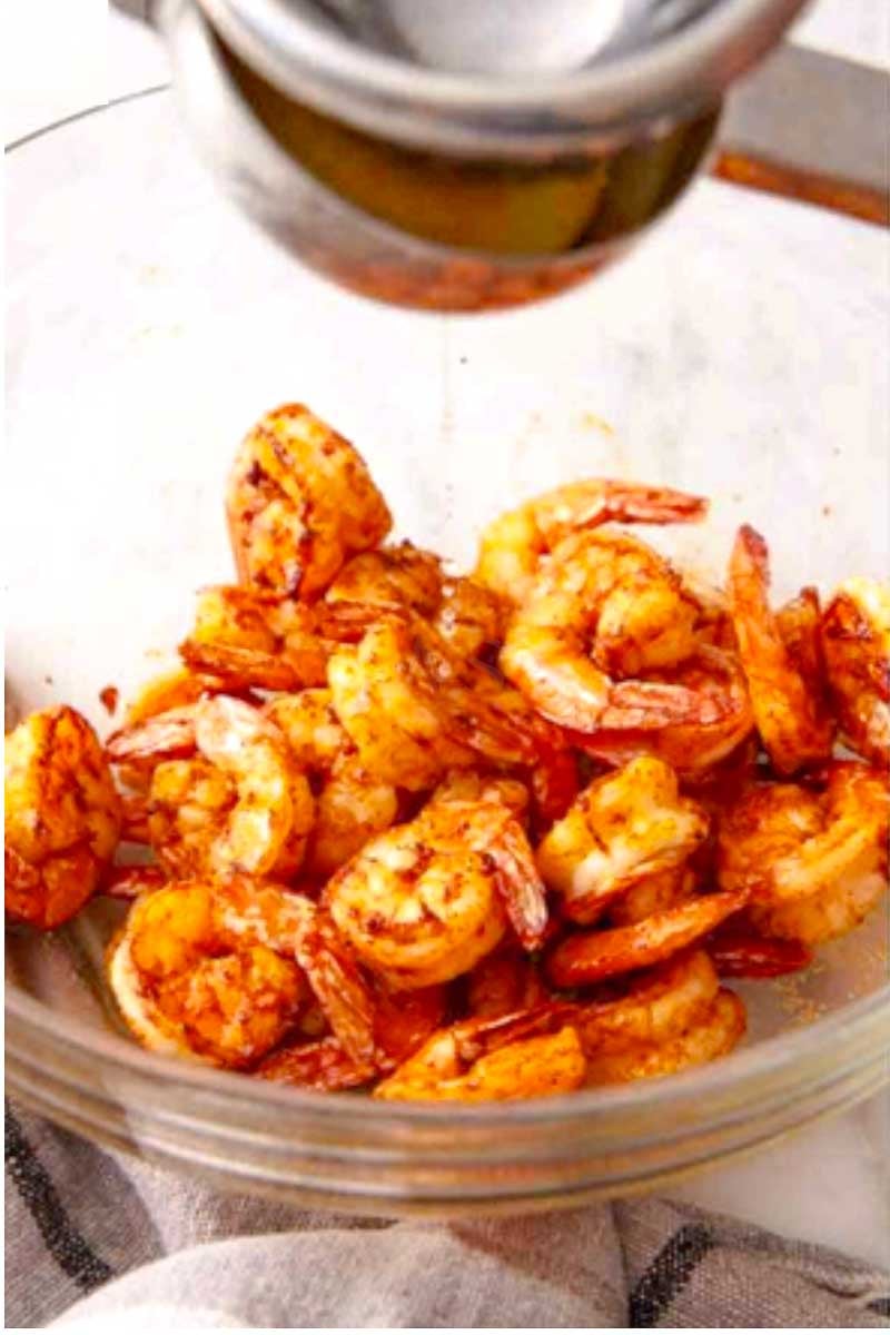 Freshly air-fried seasoned shrimp tossed with lemon juice in a glass serving bowl.