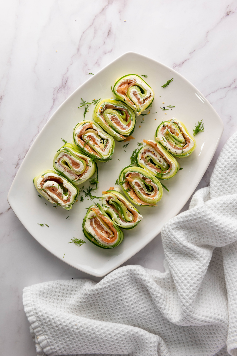 Sliced Everything Bagel Cucumber Rolls arranged on a serving platter and ready to serve.