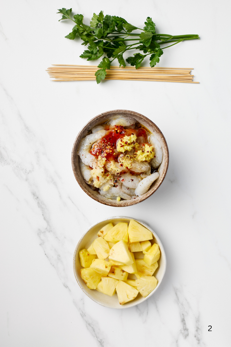 Raw shrimp tossed in sweet and spicy marinade with garlic, ginger, and chili in a bowl