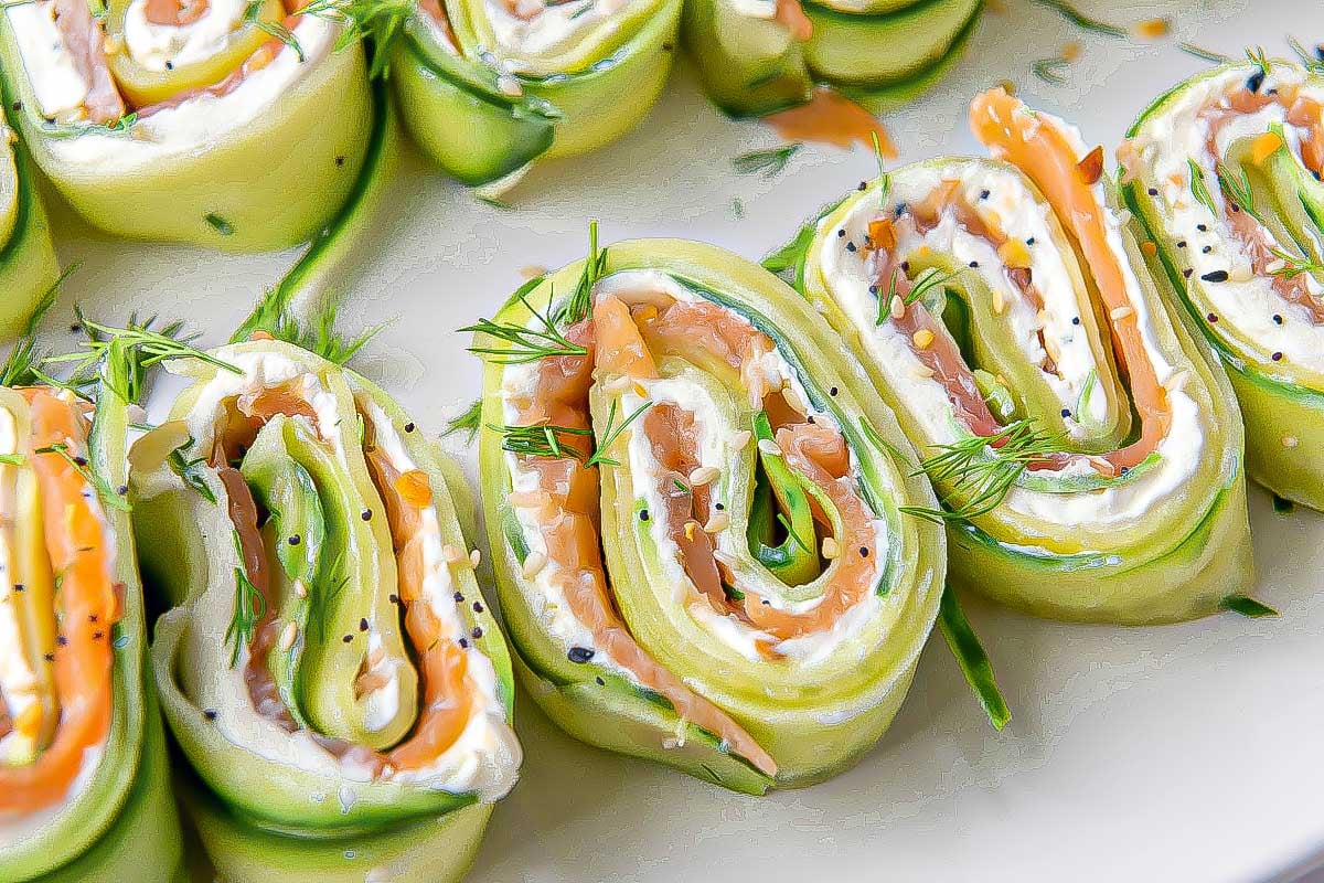 Rolling the cucumber ribbons into a tight log filled with cream cheese, smoked salmon, and everything bagel seasoning.