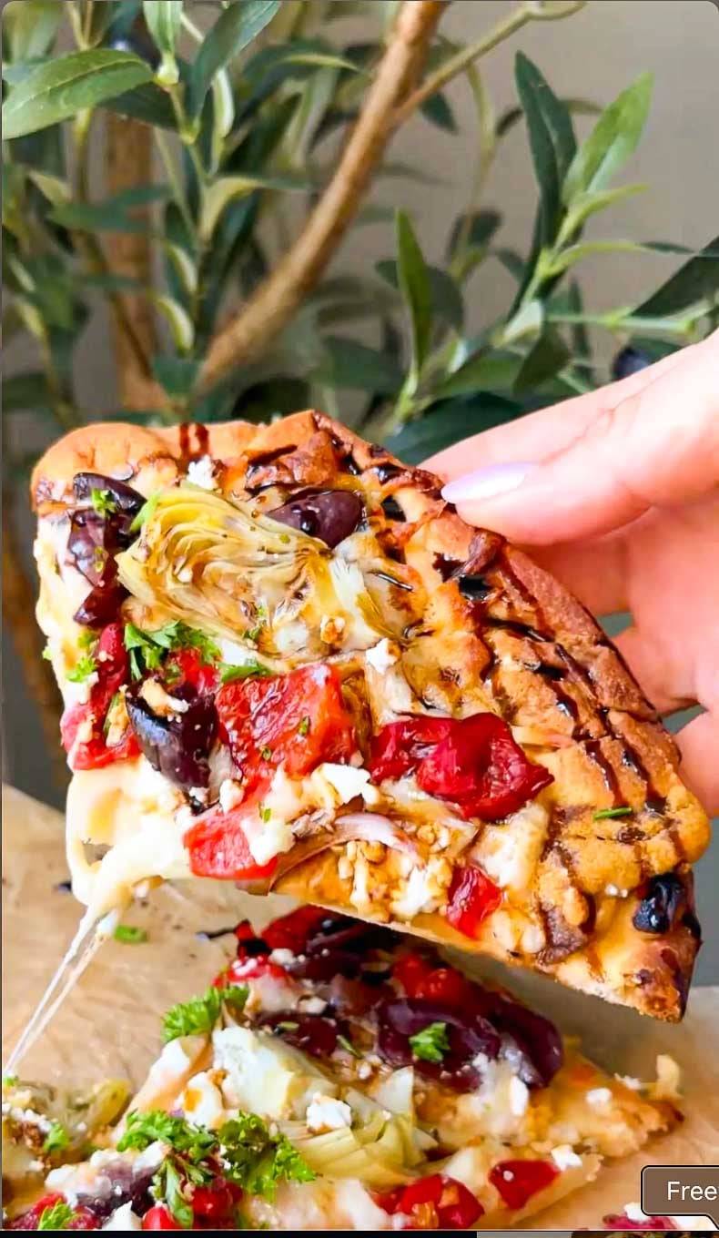 Sliced Mediterranean flatbread served warm with feta, parsley and balsamic glaze