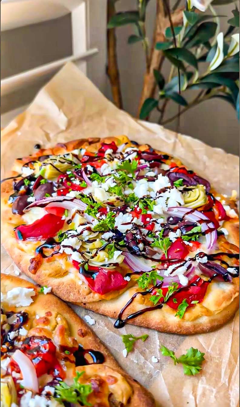 Mediterranean flatbread with hummus, feta, olives, artichokes and roasted red peppers