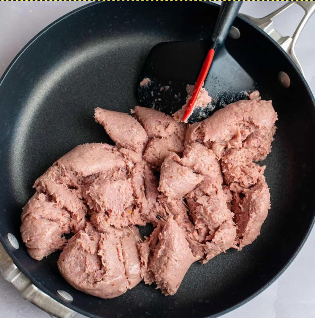 Ground turkey sausage browning in a large skillet for Egg Roll in a Bowl.