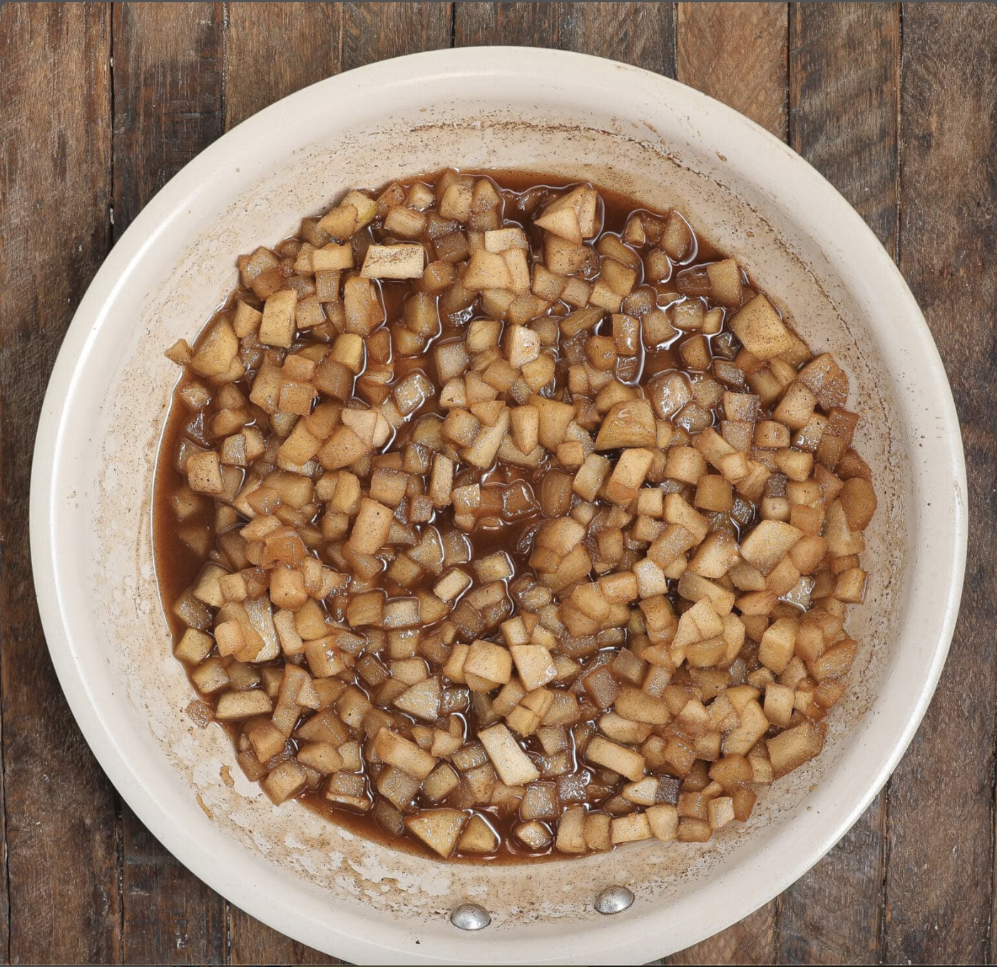 Diced apples cooking with butter, cinnamon, allspice, apple juice, vanilla and sugar for Caramel Apple Tiramisu.