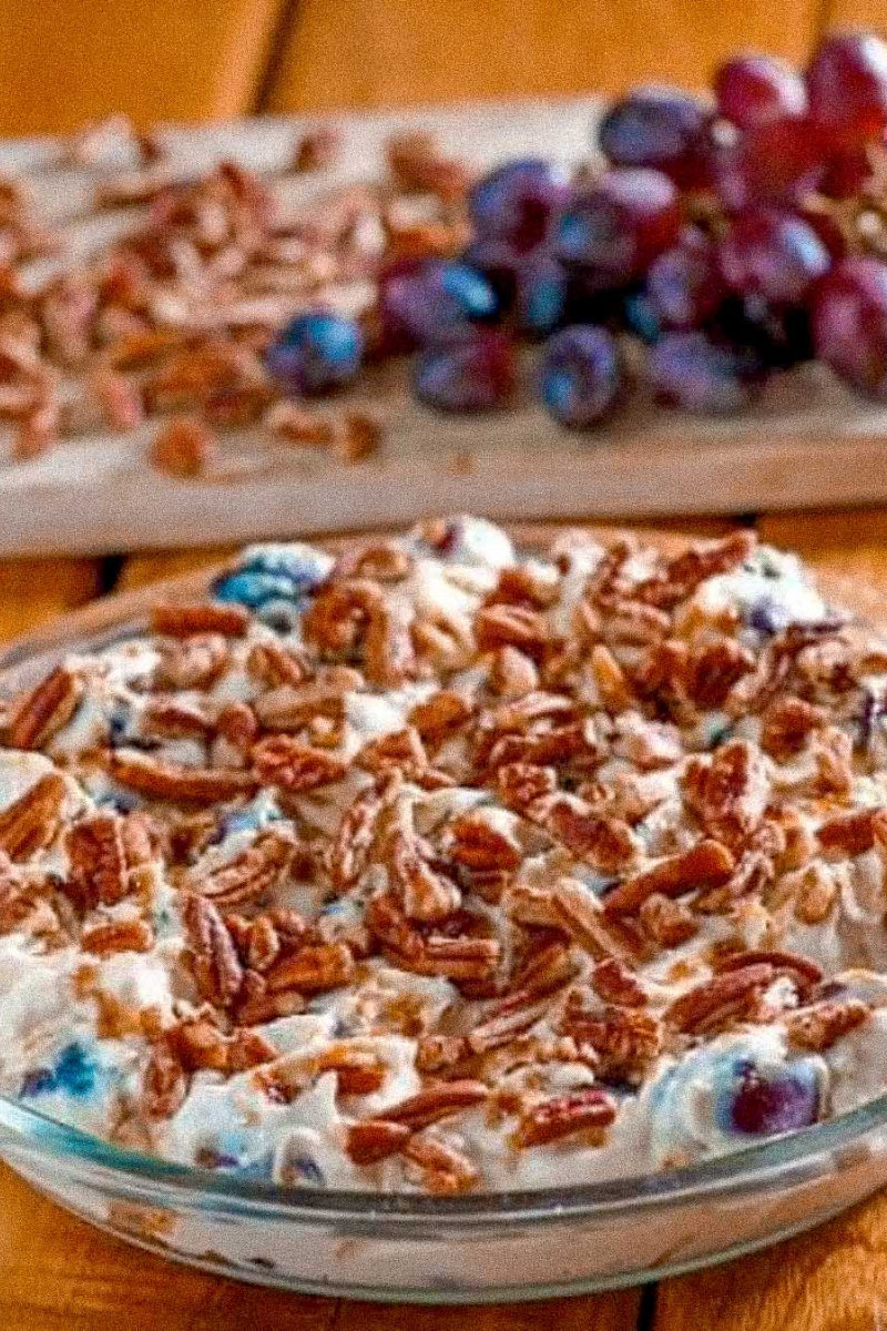 Southern grape salad topped with brown sugar and chopped pecans.