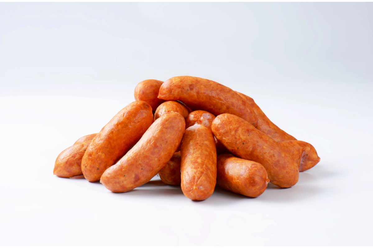 Whole smoked sausages arranged on a white surface.