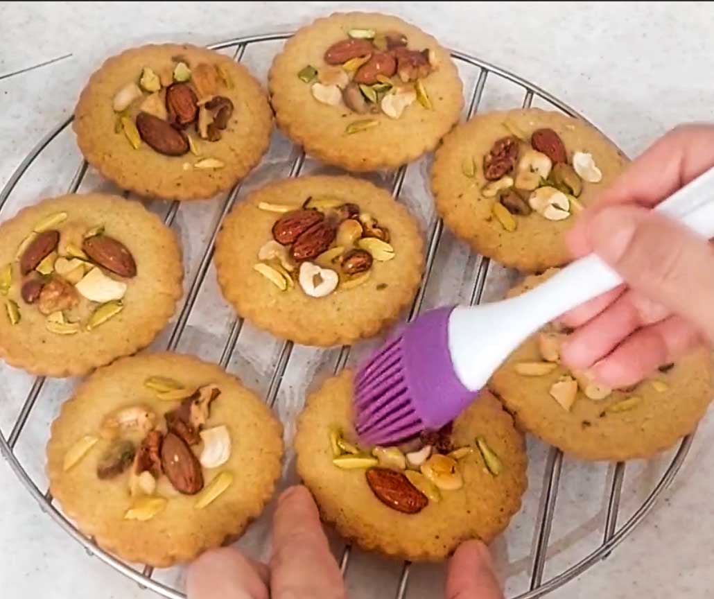 Baked baklava cookies with mixed nuts finished with a drizzle of golden honey.