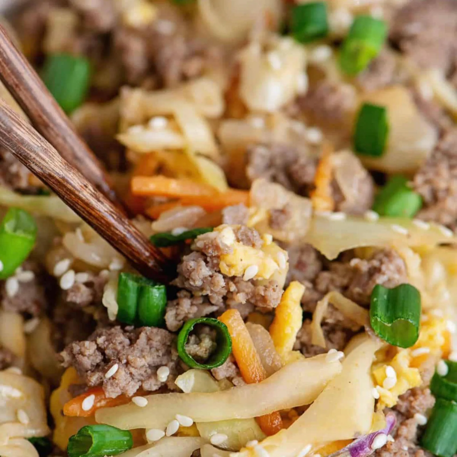 Finished Egg Roll in a Bowl with turkey sausage, cabbage, scrambled eggs, green onions and sesame seeds.