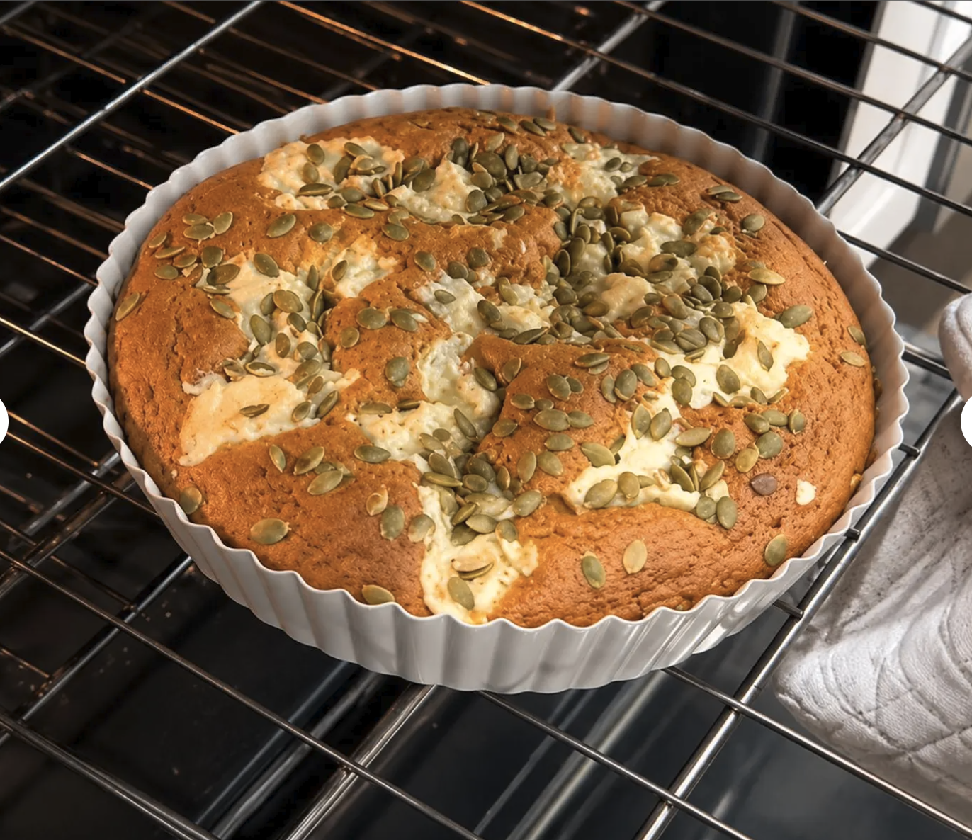 Pumpkin cream cheese cake baking until puffed and golden.

