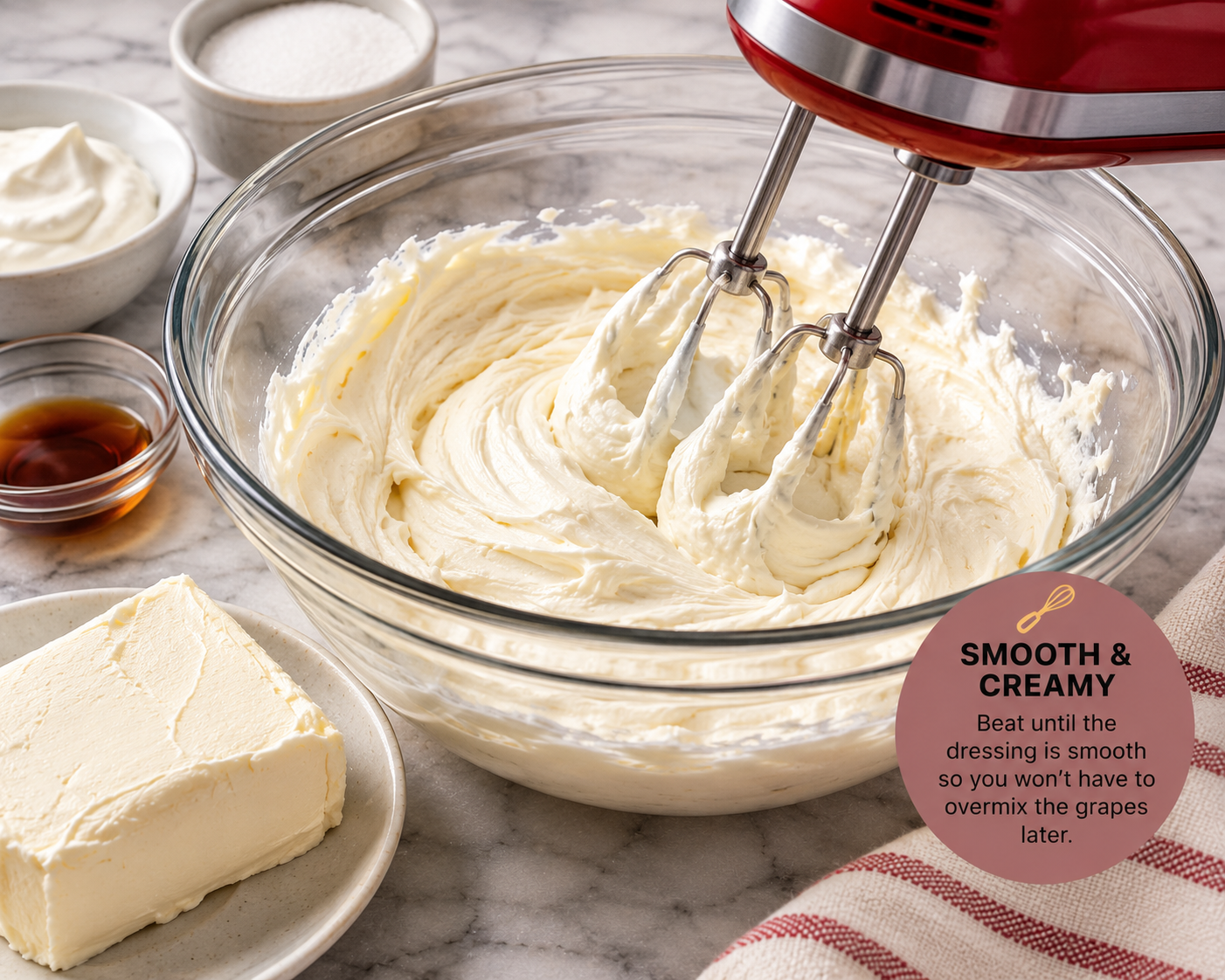 Cream cheese, sour cream, vanilla and sugar being beaten into a smooth creamy dressing for Southern grape salad.