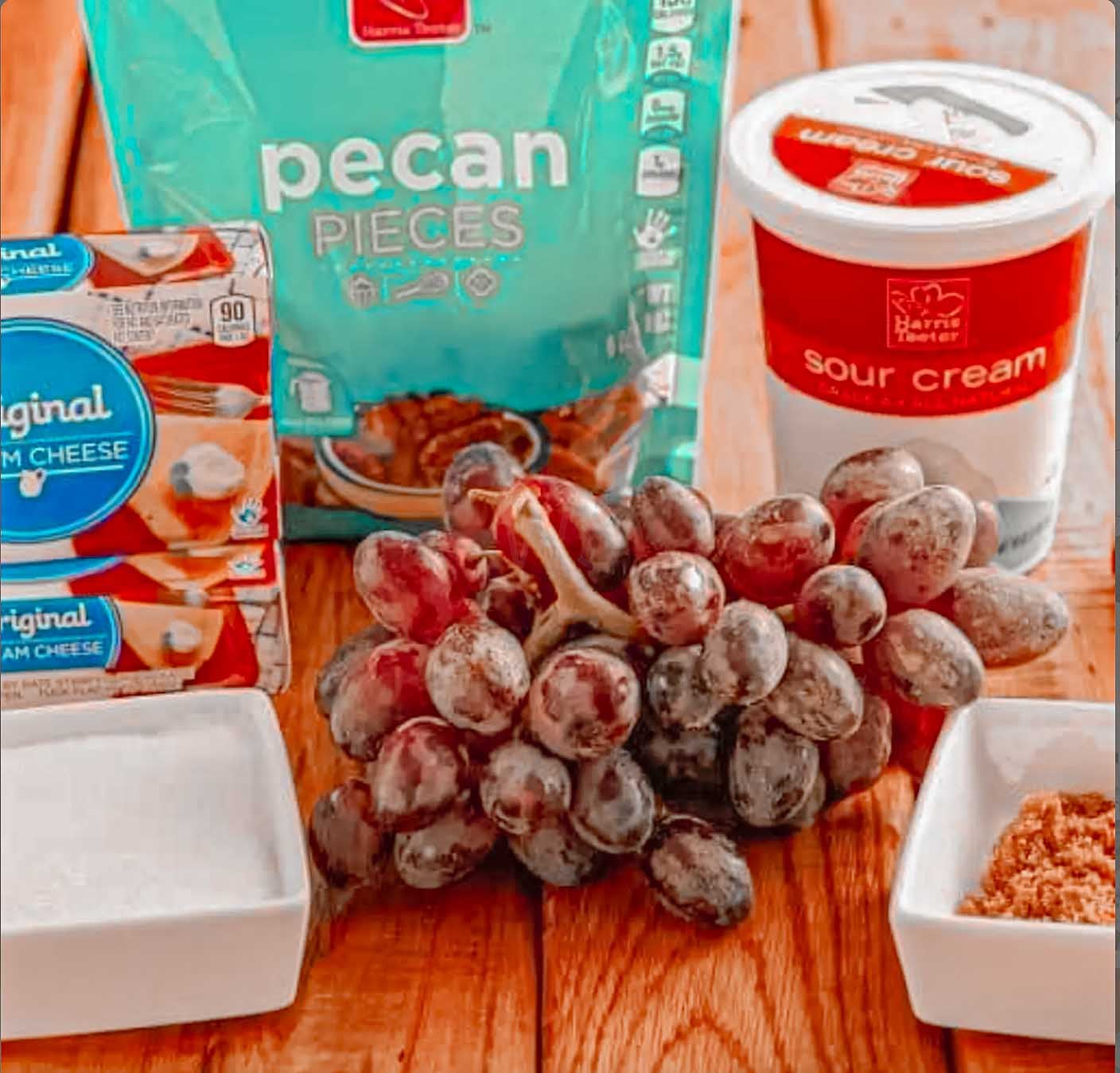 Ingredients for Southern grape salad with seedless grapes, cream cheese, sour cream, sugar, vanilla and pecans.