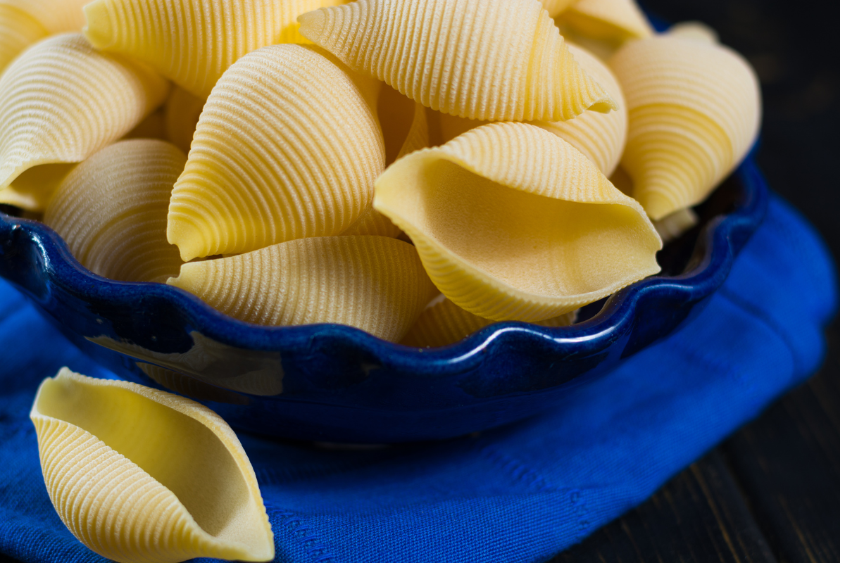 Ingredients for pumpkin ricotta stuffed shells including pasta, pumpkin, ricotta, and cheese