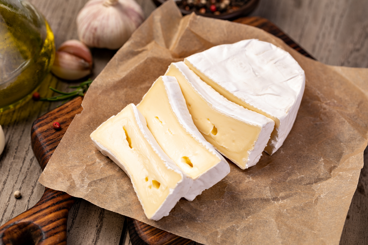 Brie cheese sliced and ready for topping the flatbread
